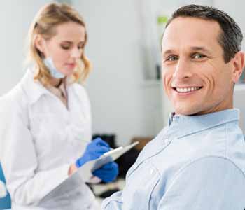 Image of a Patient sit on the Dentist chair, Dentist near the Patient