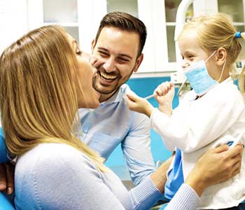 Mother, father & daughter in a dental office